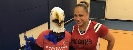 Principal posing with the Bluehawk mascot