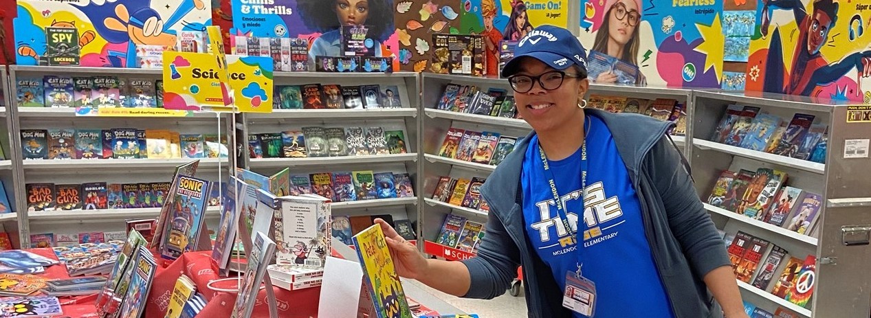 Media specialist standing in the middle of the book fair